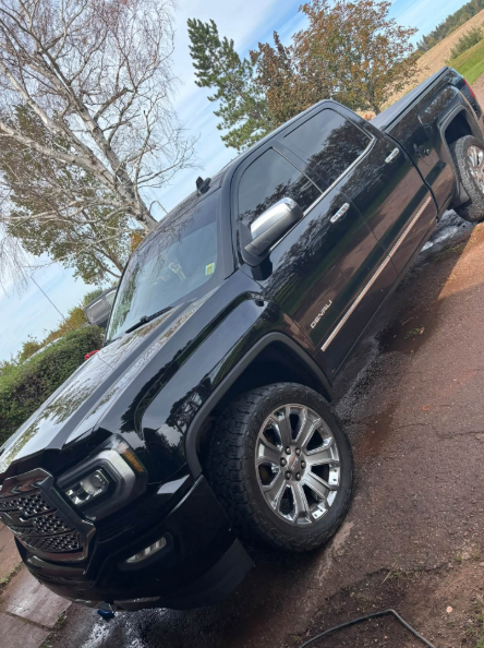 Glossy black GMC Denali truck after an exterior detail